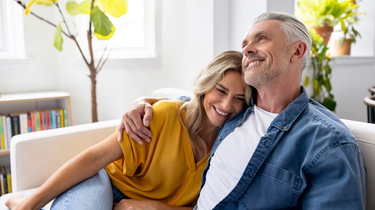 Couple cuddling on couch
