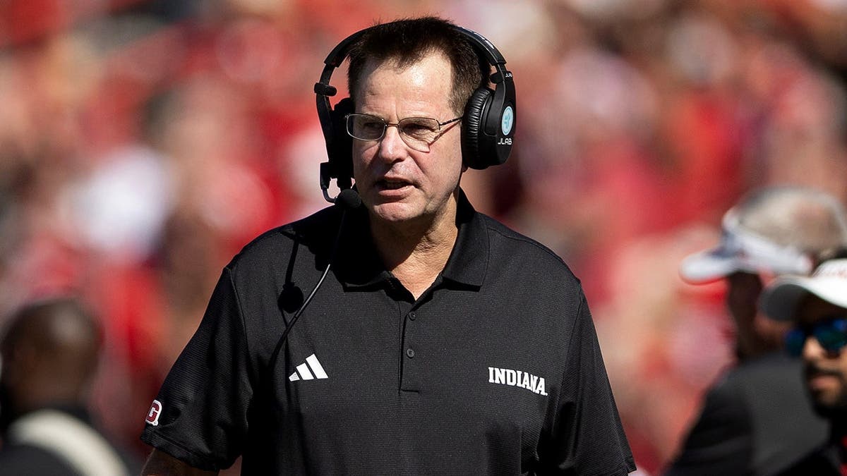 Curt Cignetti paces the sideline during an NCAA college football game.