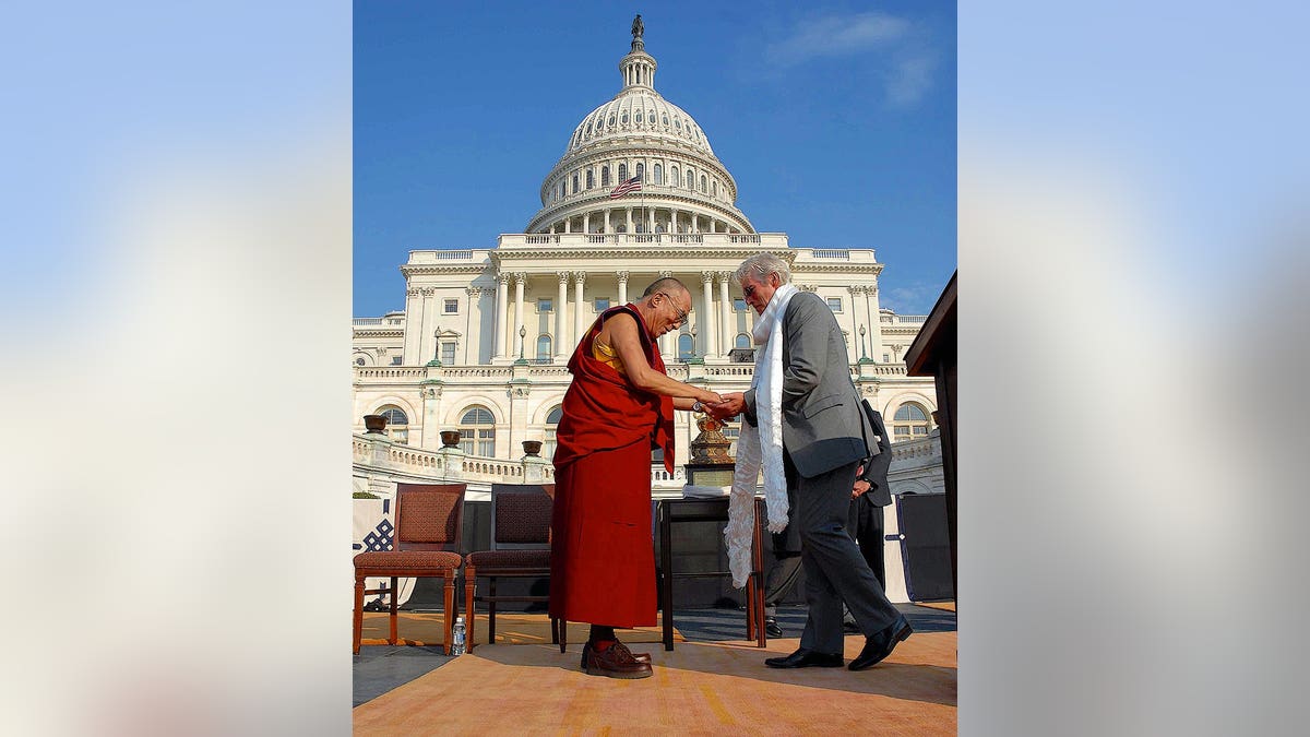 The 14th Dalai Lama presents Richard Gere with a prayer shawl at the U.S. Capitol.