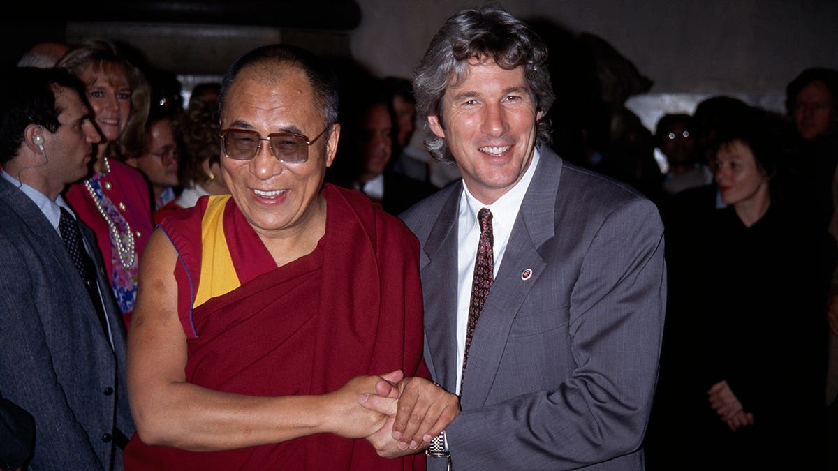 The Dalai Lama and Richard Gere stand together following a press conference at Yale College.