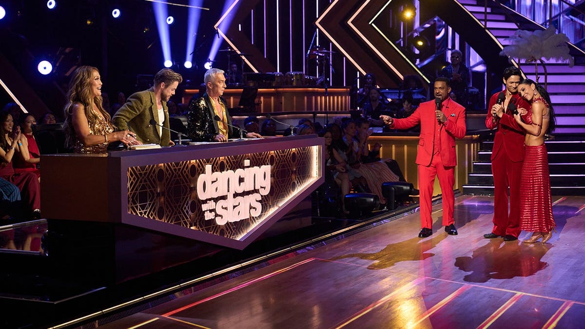 Judges Carrie Ann Inaba, Derek Hough, and Bruno Tonioli sit at the judges' table on Dancing With the Stars.
