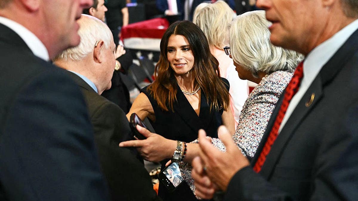 Danica Patrick stands with President Donald Trump at a campaign rally in Park City, Kansas.