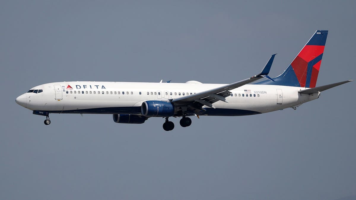 A Delta Airlines plane in the air.