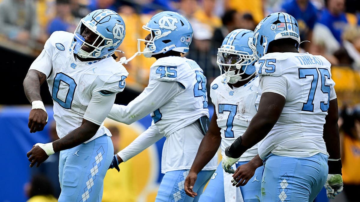 Demon June celebrates after scoring a touchdown for North Carolina.
