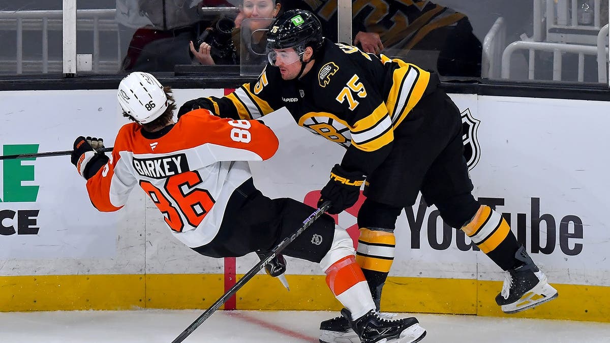 Denver Barkey and Connor Clifton collide during an NHL hockey game in Boston.
