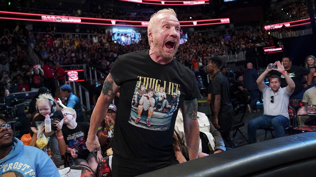 Diamond Dallas Page sits in the audience at State Farm Arena.