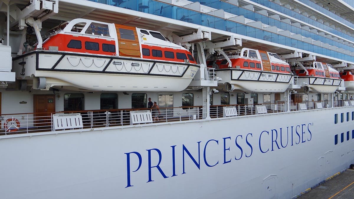 Diamond Princess luxury liner anchored at Ōsanbashi Pier in Yokohama Port with lifeboats visible.