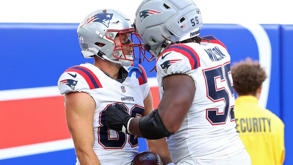 Efton Chism III celebrates with Jared Wilson after scoring a touchdown against the Buffalo Bills.