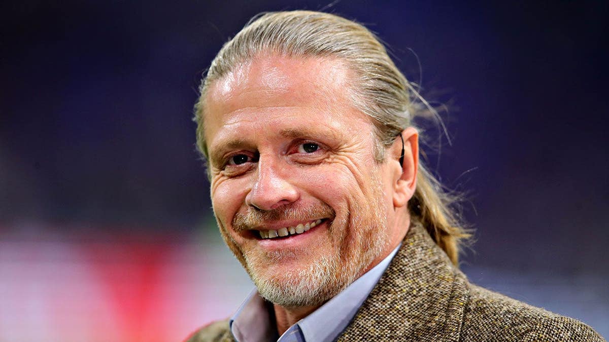 Emmanuel Petit looks on before the UEFA Champions League match at Groupama Stadium.