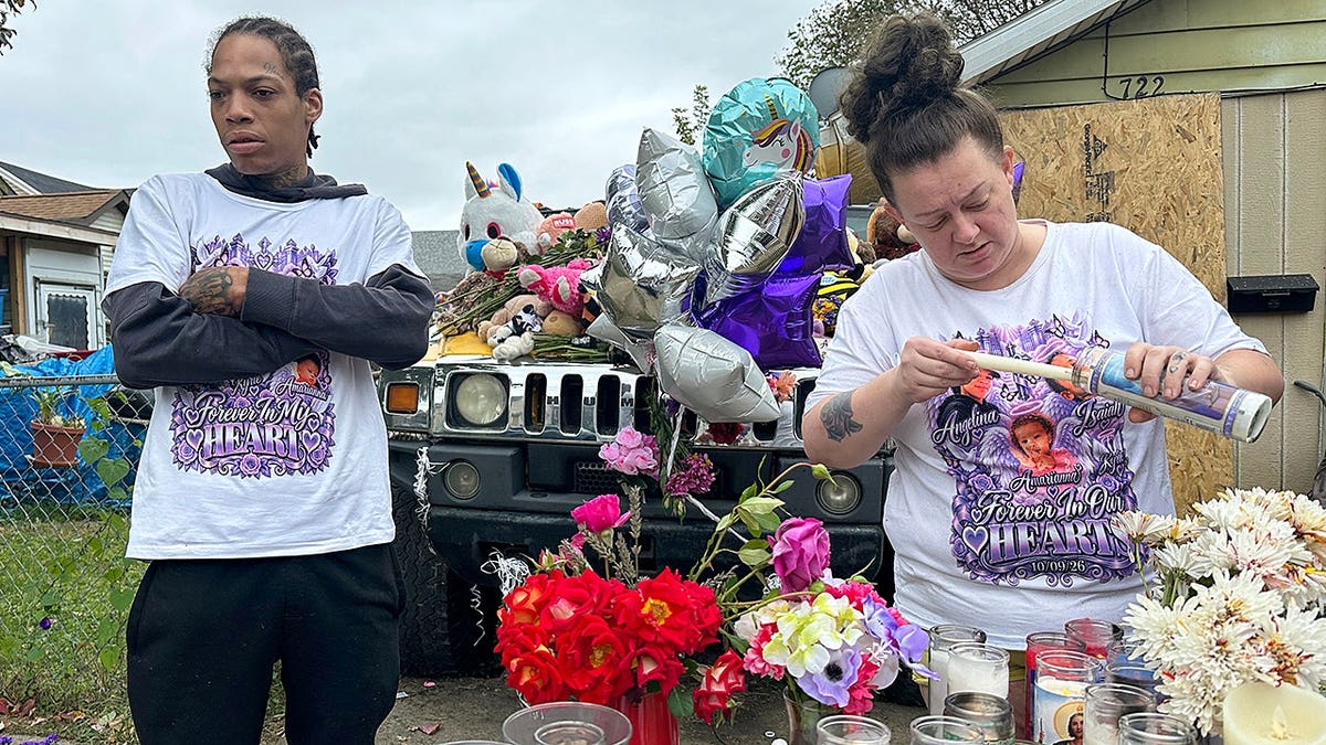 Julius Windham visits a memorial outside a home in Erie, Pa., where a shooting occurred.
