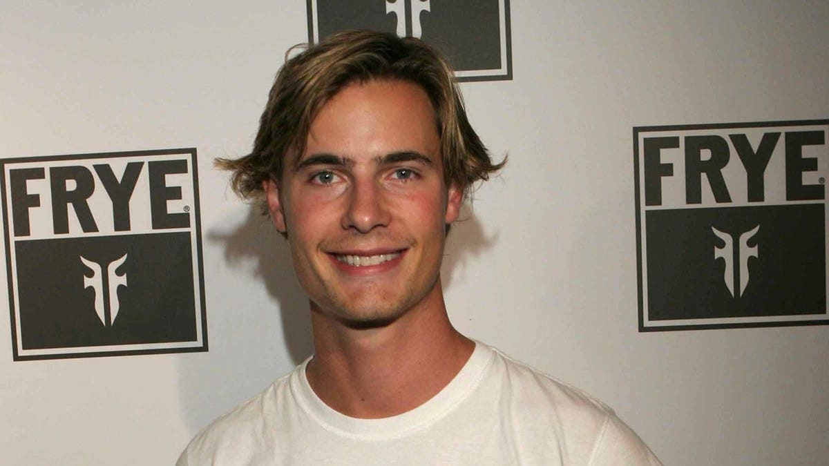 Erik von Detten stands at an event arrival area.