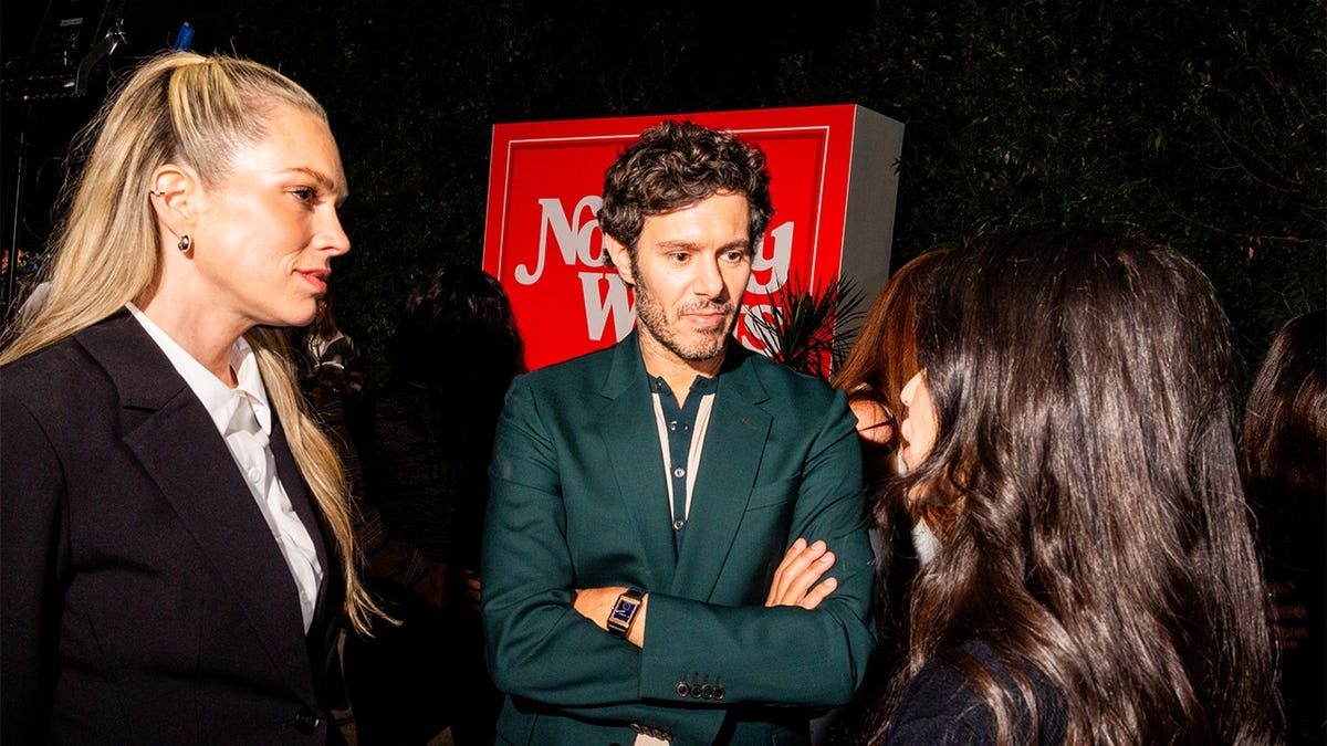 Erin Foster and Adam Brody stand together at the Nobody Wants This S3 Housewarming Party.