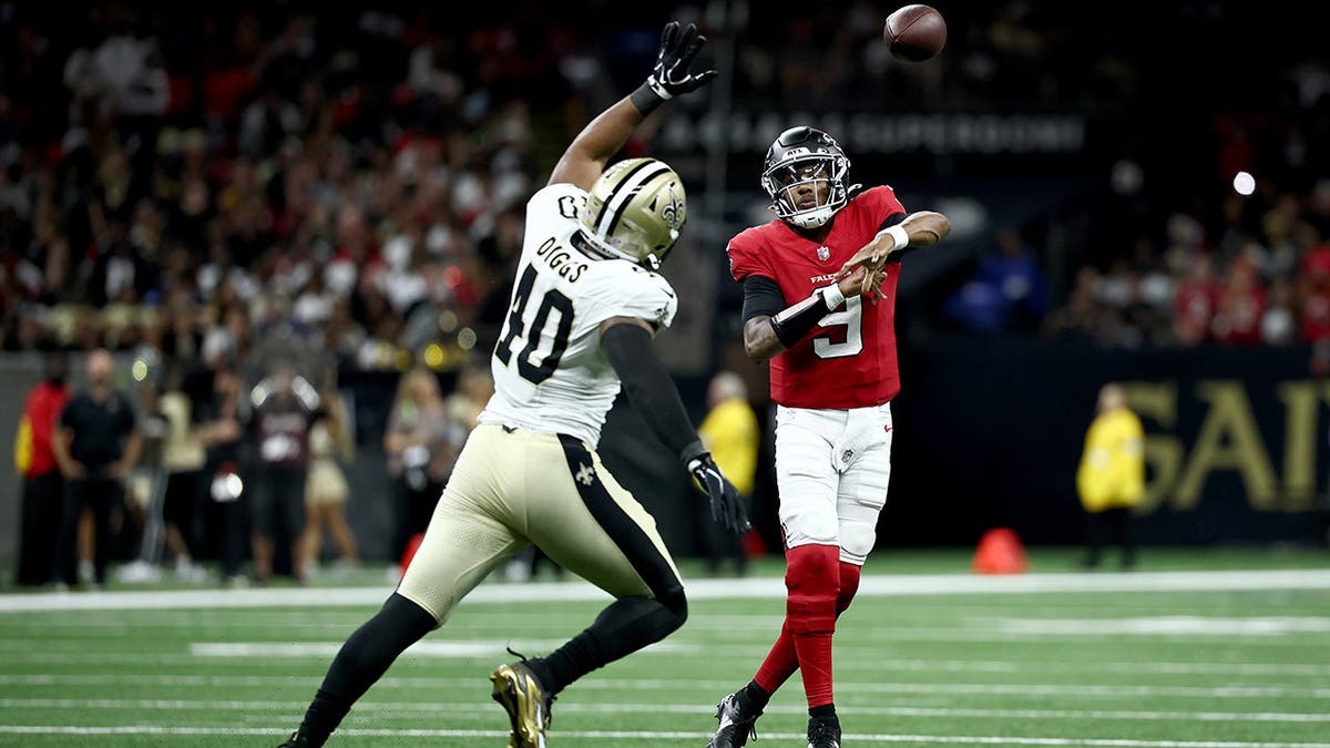 Fadil Diggs of the New Orleans Saints blocks a pass from Michael Penix Jr. of the Atlanta Falcons.