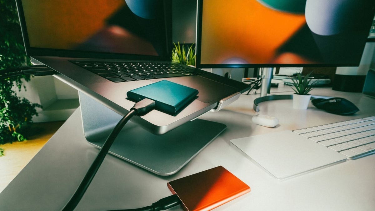 A laptop with an external hard drive