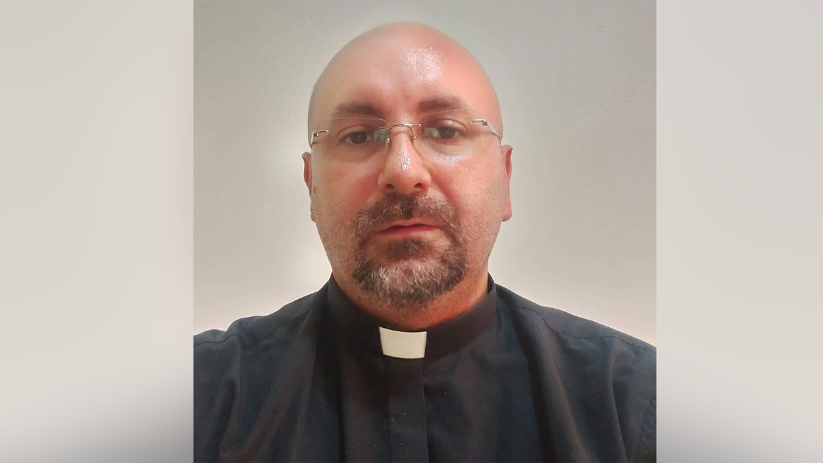 Father Patricio Alfredo Sánchez Molinari wearing glasses and a black clerical shirt