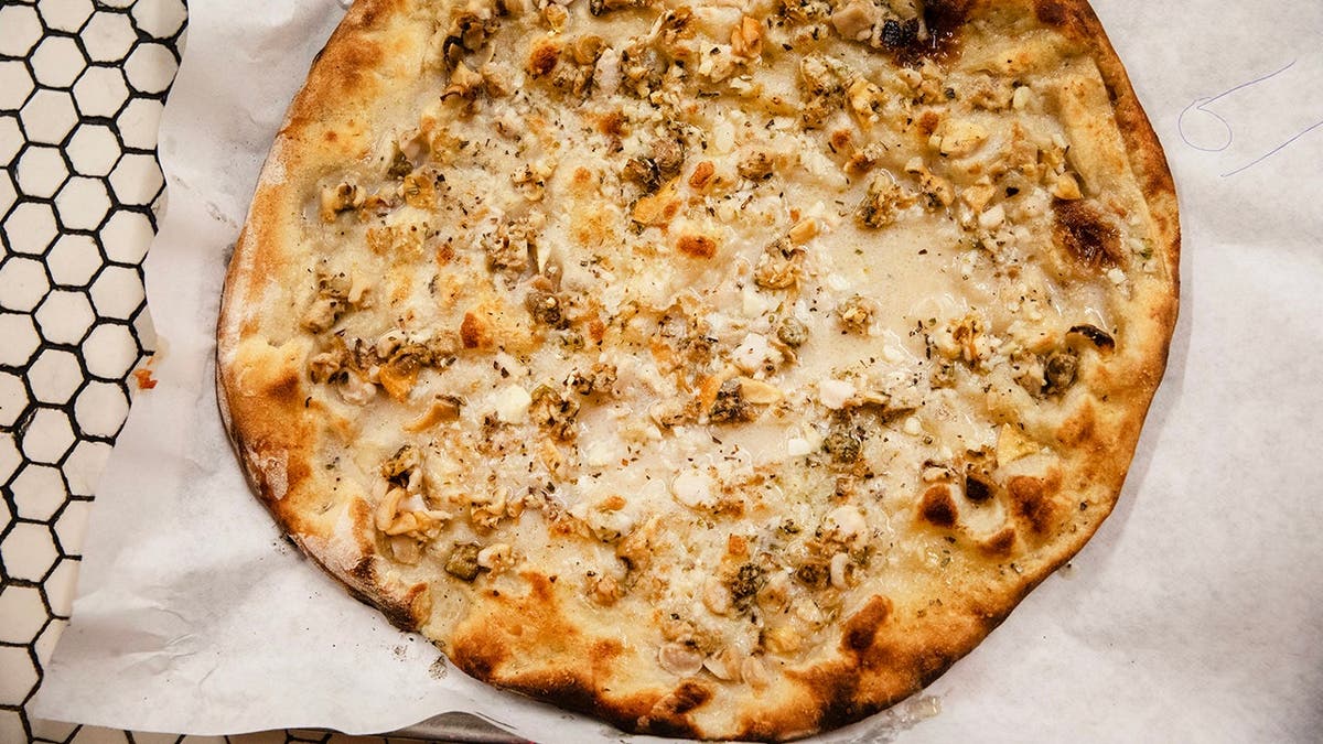 Clam pie sits at Frank Pepe Pizzeria Napoletana in New Haven, Connecticut.