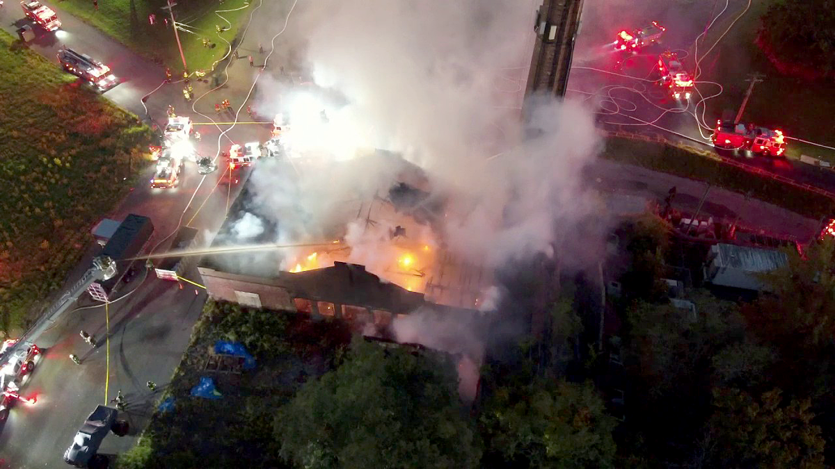 Fire crews work to control a warehouse fire