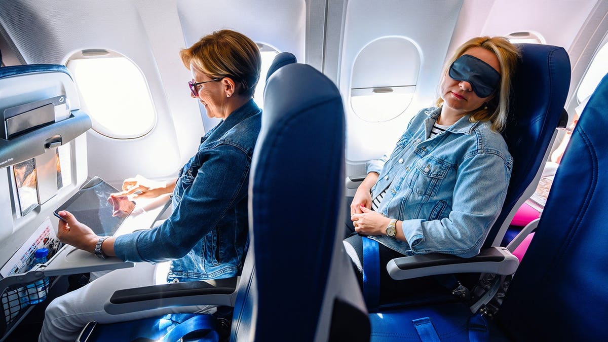 Female passenger seated on a commercial airplane.