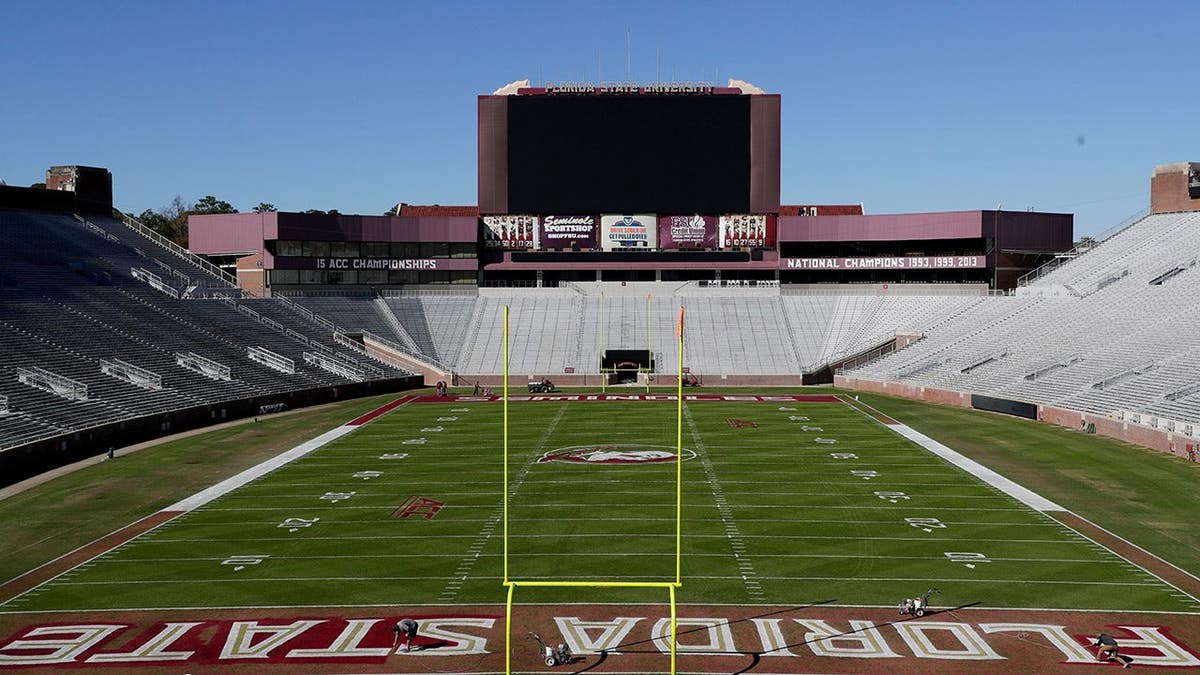 A crew paints Bobby Bowden Field at Doak Campbell Stadium.
