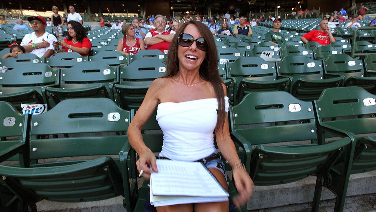Amy Williams, known as Front Row Amy, sits behind home plate at Miller Park.