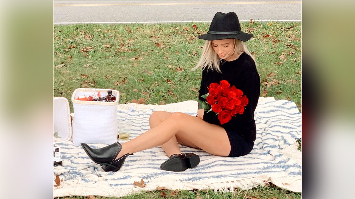image shows photo of victim holding flowers