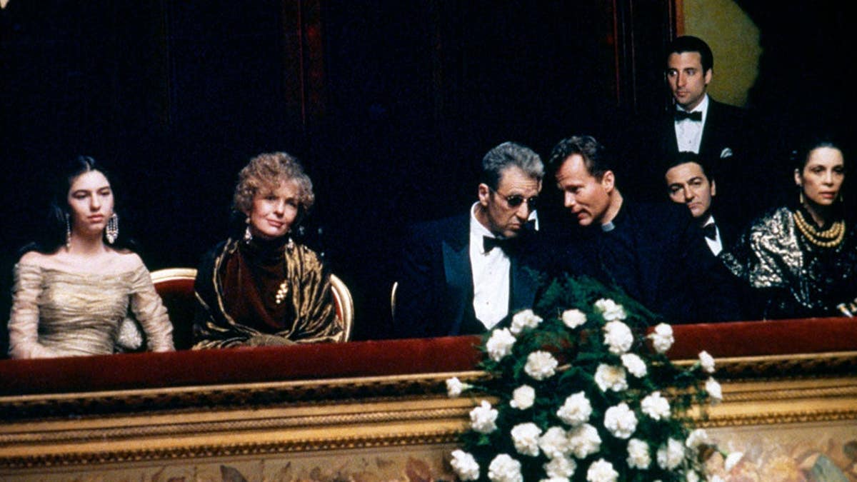 Sofia Coppola, Diane Keaton, Al Pacino, John Savage, Don Novello, Andy Garcia and Talia Shire stand together on a film set.