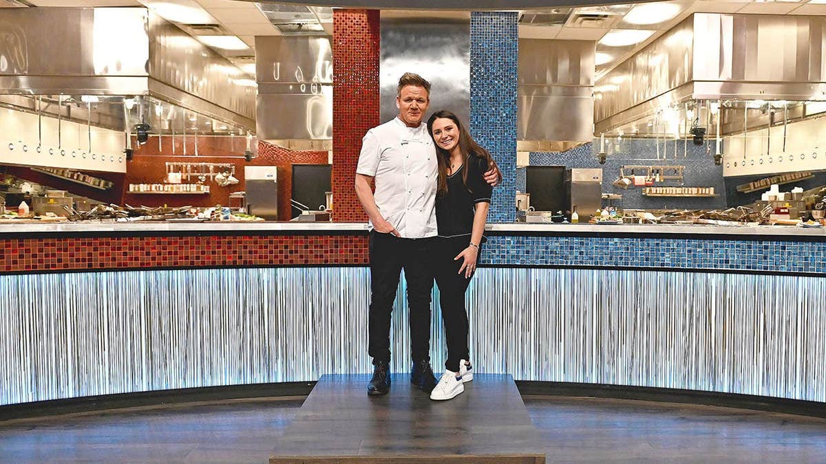 Gordon Ramsay and Megan Ramsay stand together on the Hell's Kitchen set.