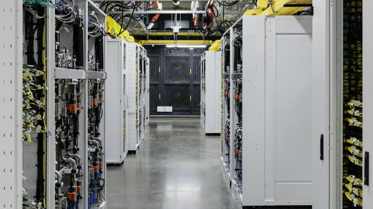 Racks of GPUs with a closed-loop liquid cooling system are seen inside an operational Microsoft data center