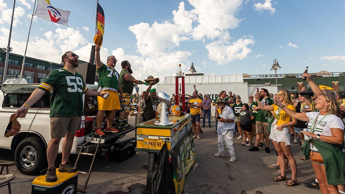 Green Bay Packers fans recite the Wedge of Allegiance outside Lambeau Field.