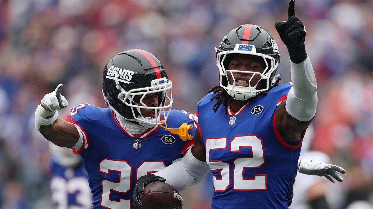 Greg Newsome II and Arvell Reese of the New York Giants react after a play.