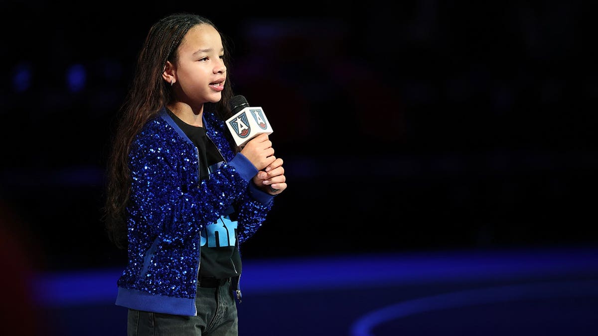 Heiress Harris performs the national anthem at center court.