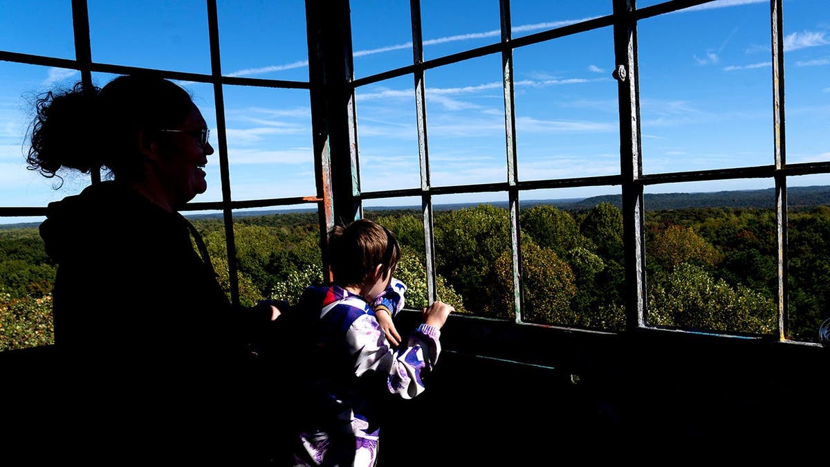 Visitors look out from Hickory Ridge Lookout Tower overlooking Charles C. Deam Wilderness.