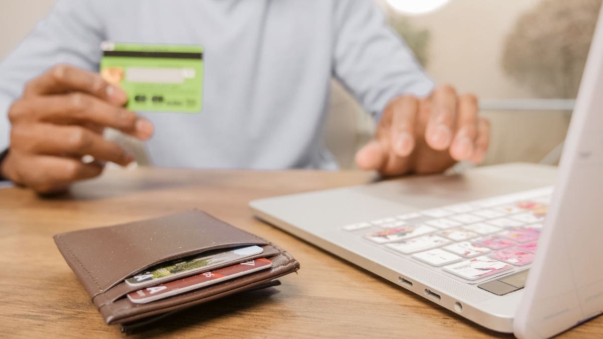 A person looking at a credit card