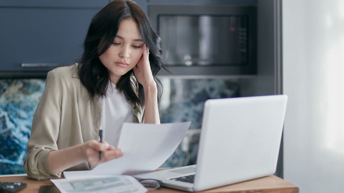 A woman looking at a bank statement
