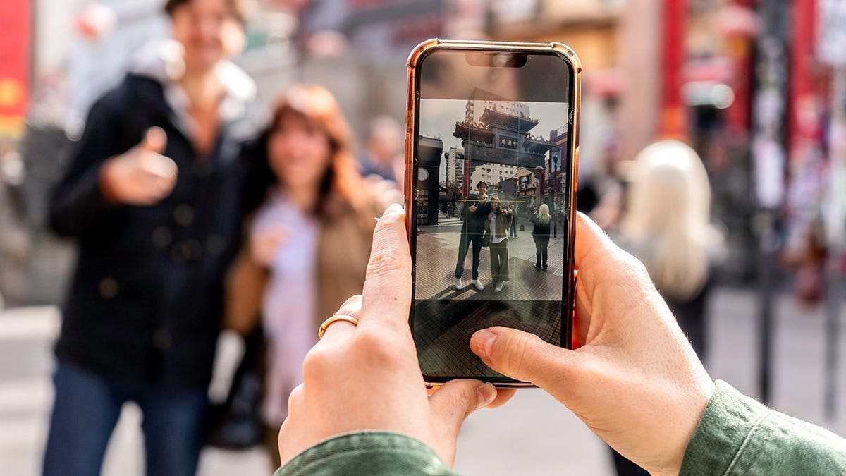 A person takes a picture on a phone.