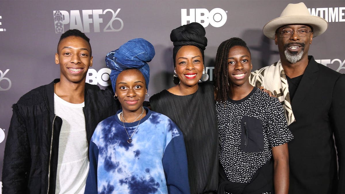 Isaiah Washington red carpet with family.