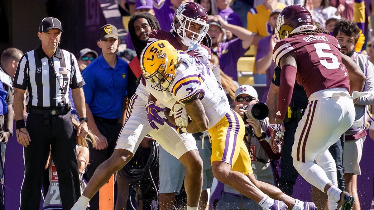 Jackson Harris scores a touchdown against Mississippi State defenders Jett Jefferson and Jardin Gilbert.