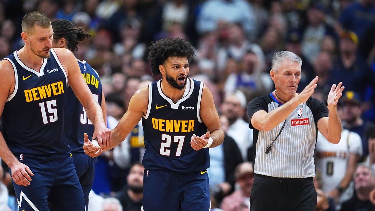 Jamal Murray argues a call with referee Scott Foster as Nikola Jokić looks on.