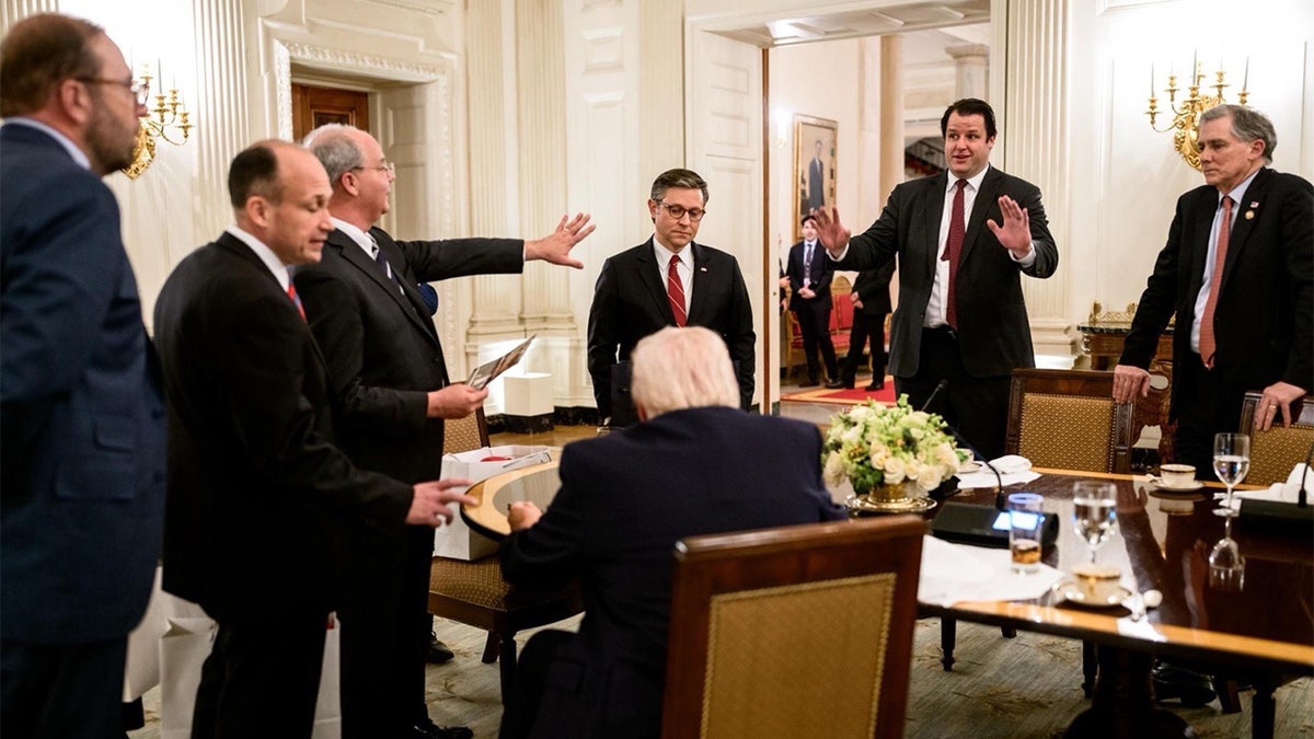 Lawmakers debate amongst themselves in front of President Trump