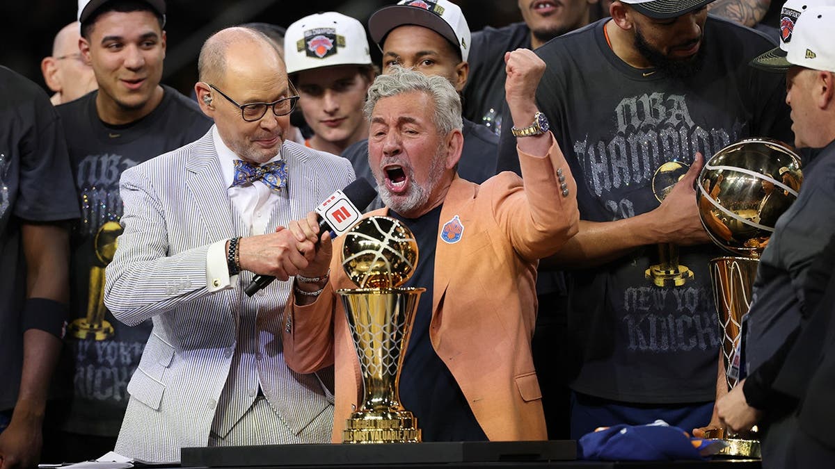 James Dolan, New York Knicks owner, is interviewed by ESPN broadcaster Ernie Johnson during a trophy ceremony.