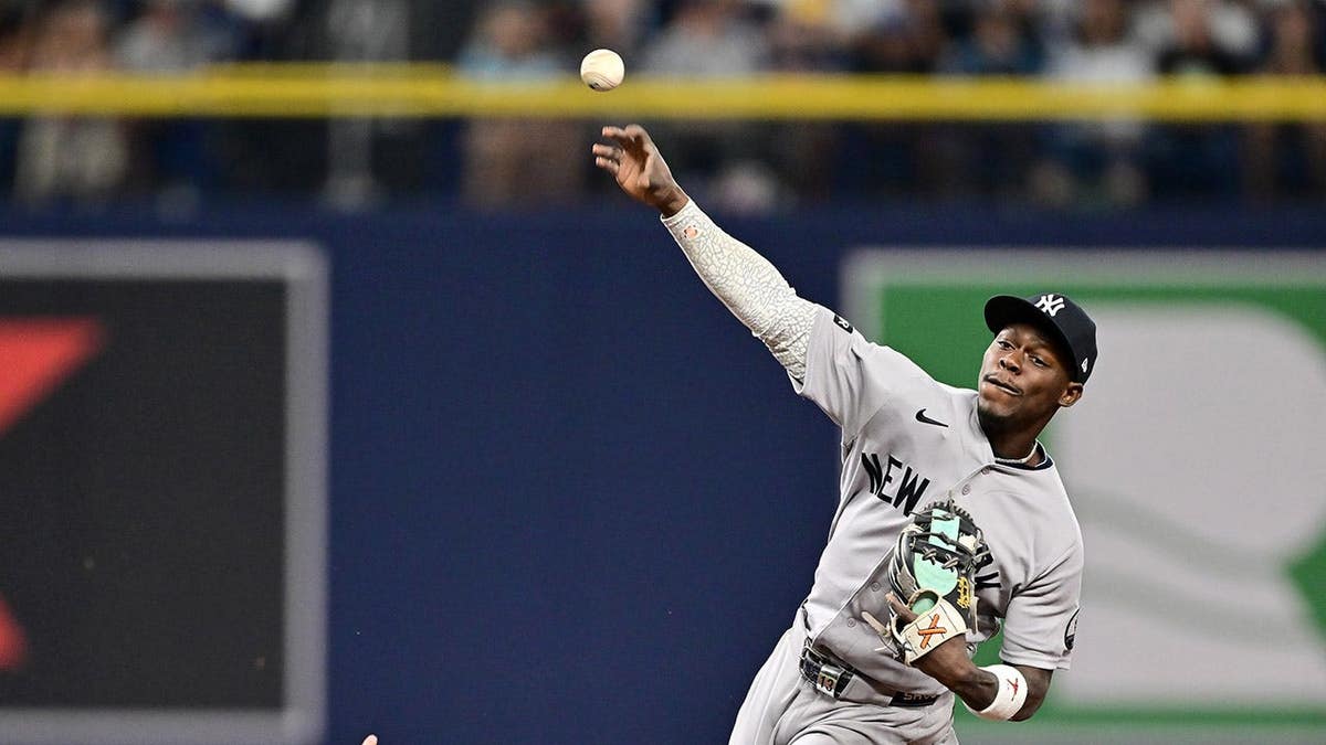 Jazz Chisholm Jr. of the Yankees attempts a double play as Jonathan Aranda of the Rays is out at second base.