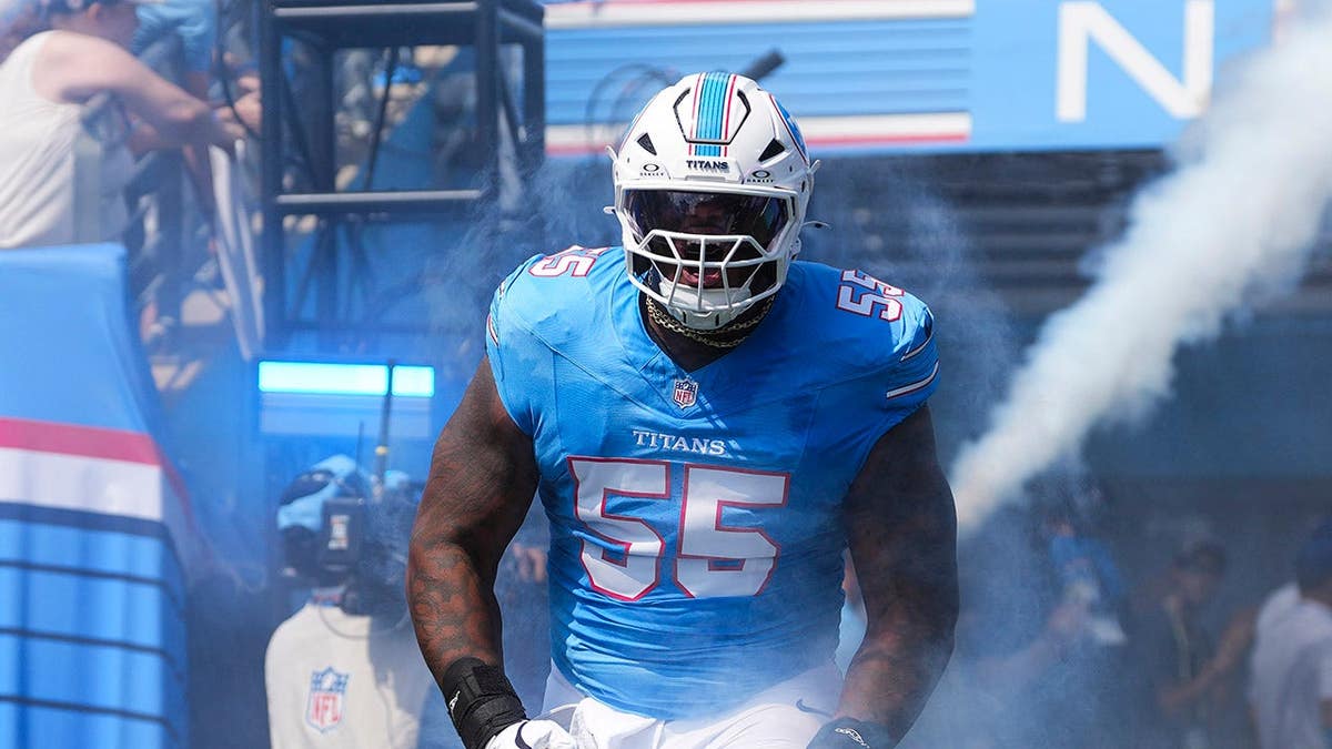 JC Latham #55 runs out before an NFL game at Nissan Stadium.