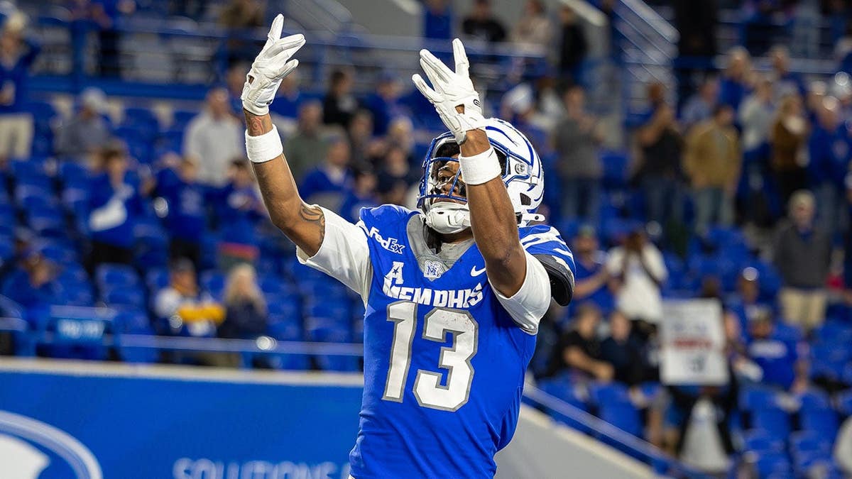 Jemyri Davis, number 13, celebrates after a touchdown during a Memphis Tigers game.