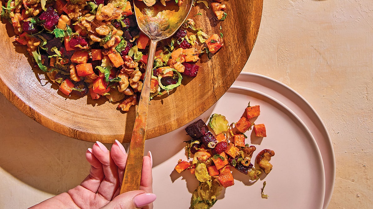 Photo from Jenn Lueke cookbook showing sweet potato, beet and brussels sprouts salad.