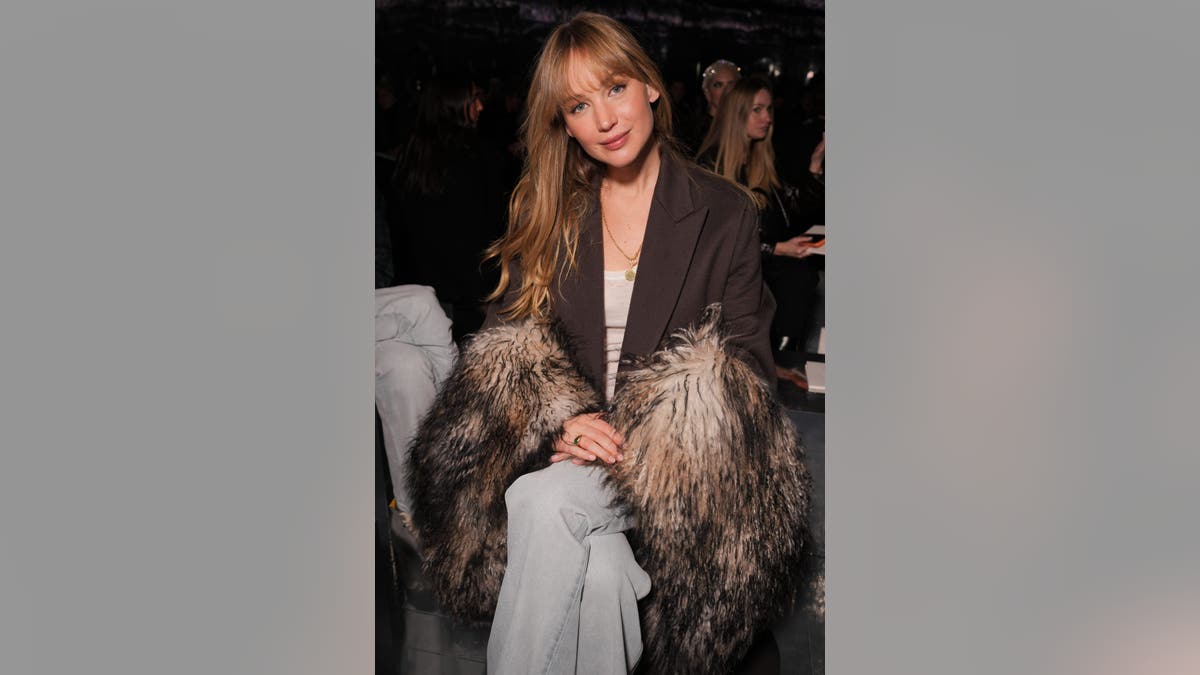 Jennifer Lawrence stands at the Dior fashion show in Paris.