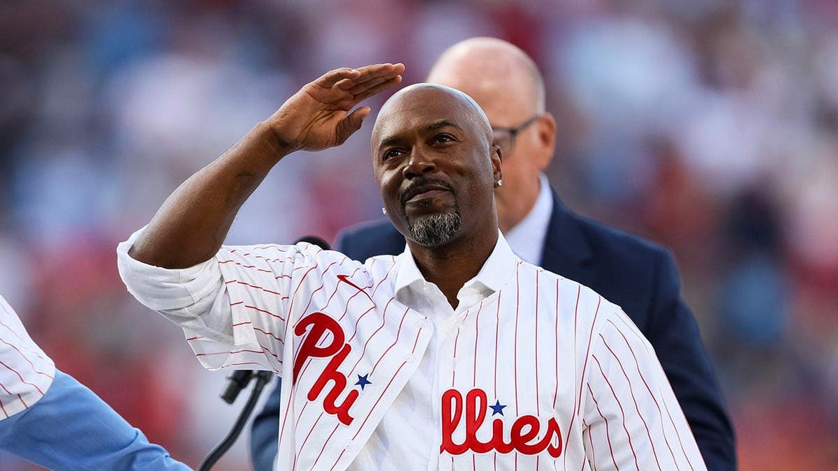Jimmy Rollins receives his jersey from Mike Schmidt during Wall of Fame ceremony at Citizens Bank Park.