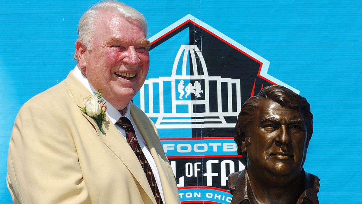 John Madden poses with his Pro Football Hall of Fame bust.