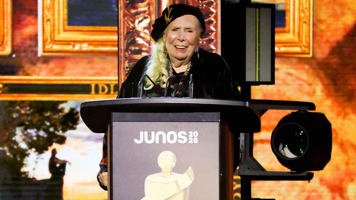Joni Mitchell accepts the Lifetime Achievement award onstage at the JUNO Awards.