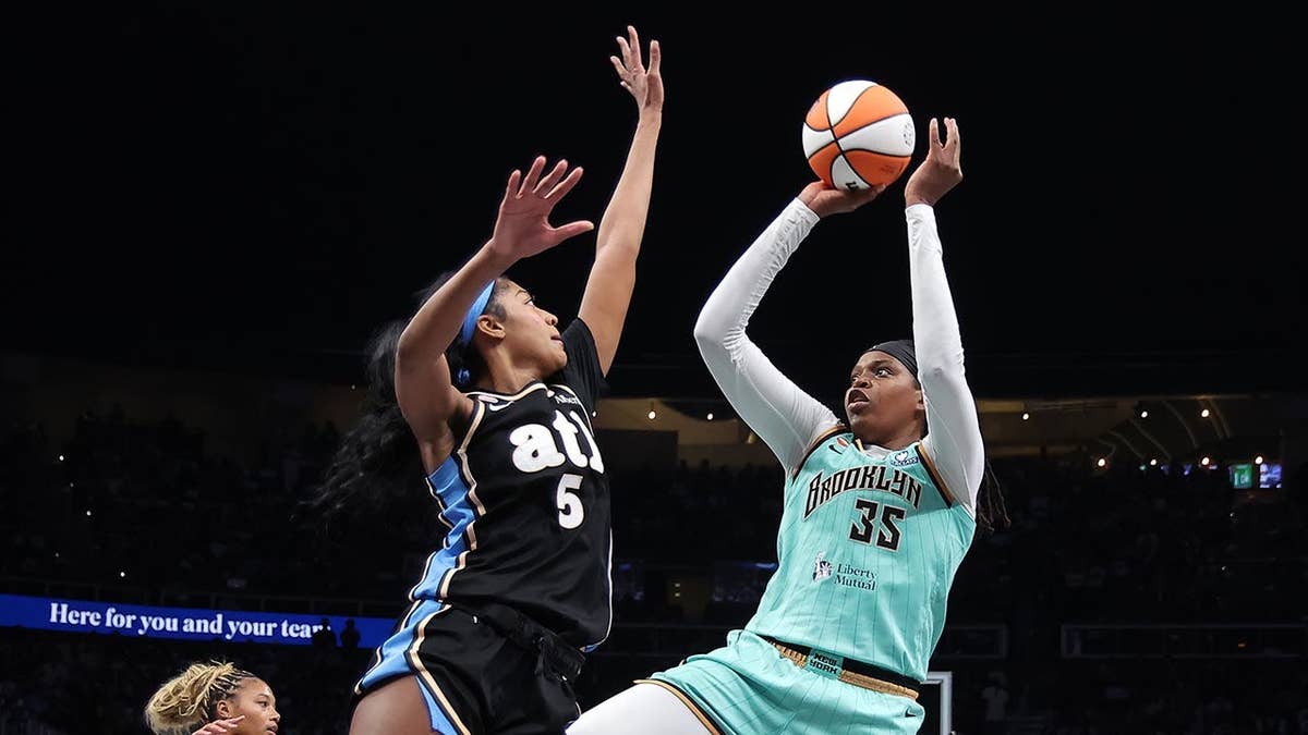 Jonquel Jones of the New York Liberty shoots against Angel Reese of the Atlanta Dream.