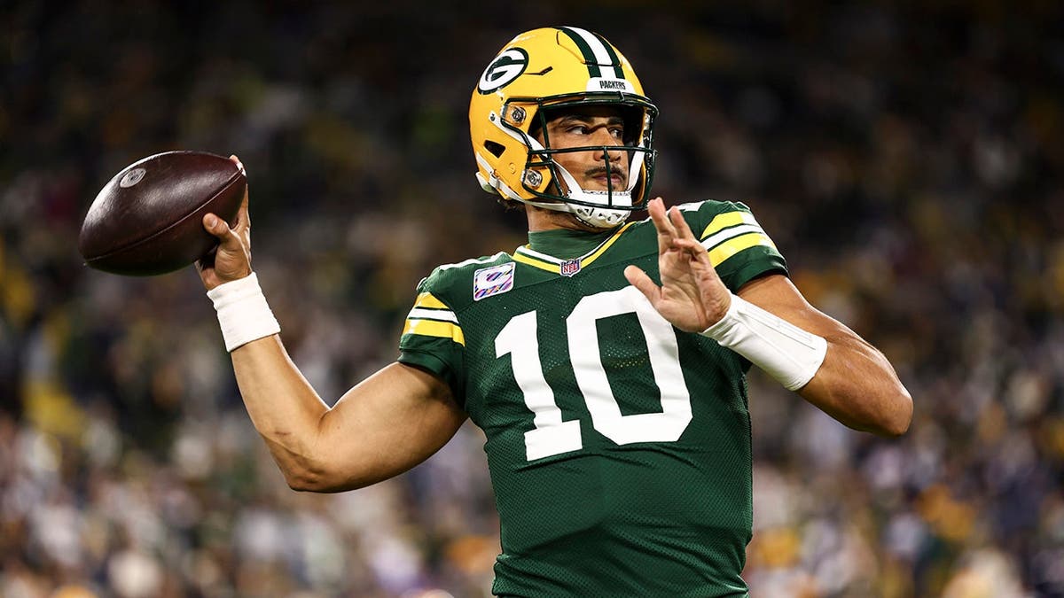 Jordan Love warms up before an NFL game at Lambeau Field.
